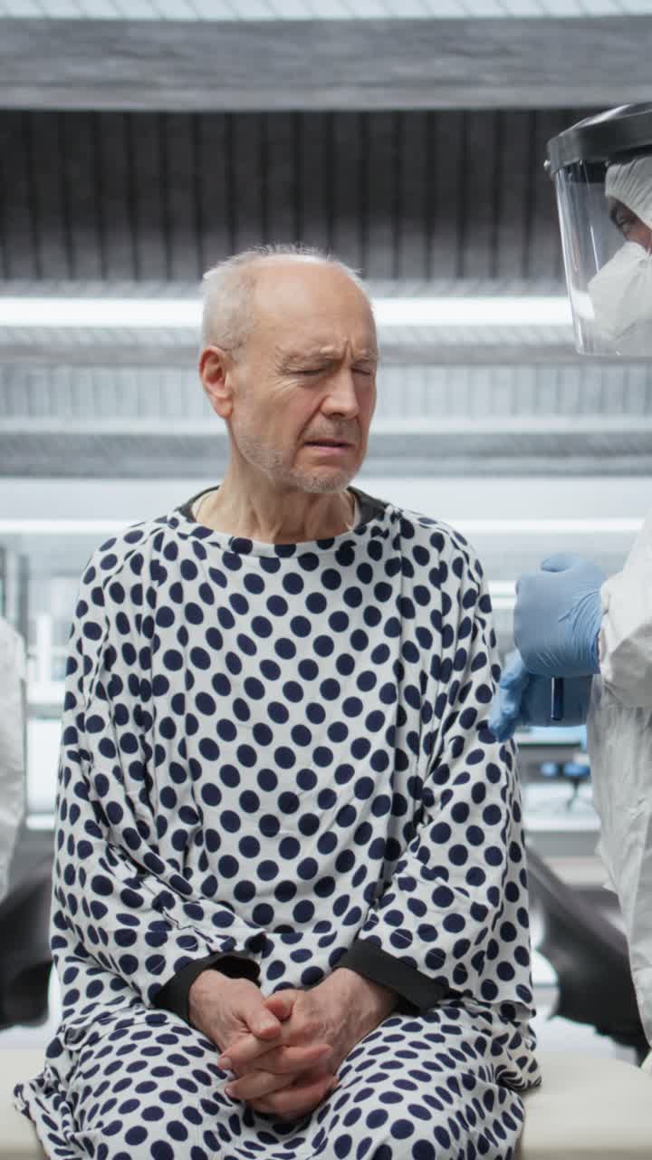 Vertical Video Expert in a protective suit studies immune response on infected patient