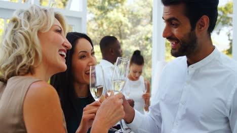 Friends-toasting-champagne-glasses-in-restaurant