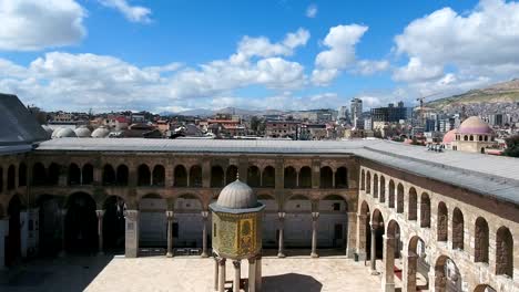 aerial view of the center of the umayyad mosque in syria. drone is flying in the inner courtyard of the mosque, where we see the building exterior inside the mosque.