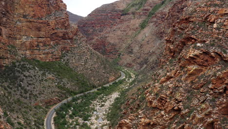 entering a canyon with winning road south africa aerial shot