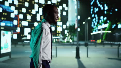 african american man walks downtown