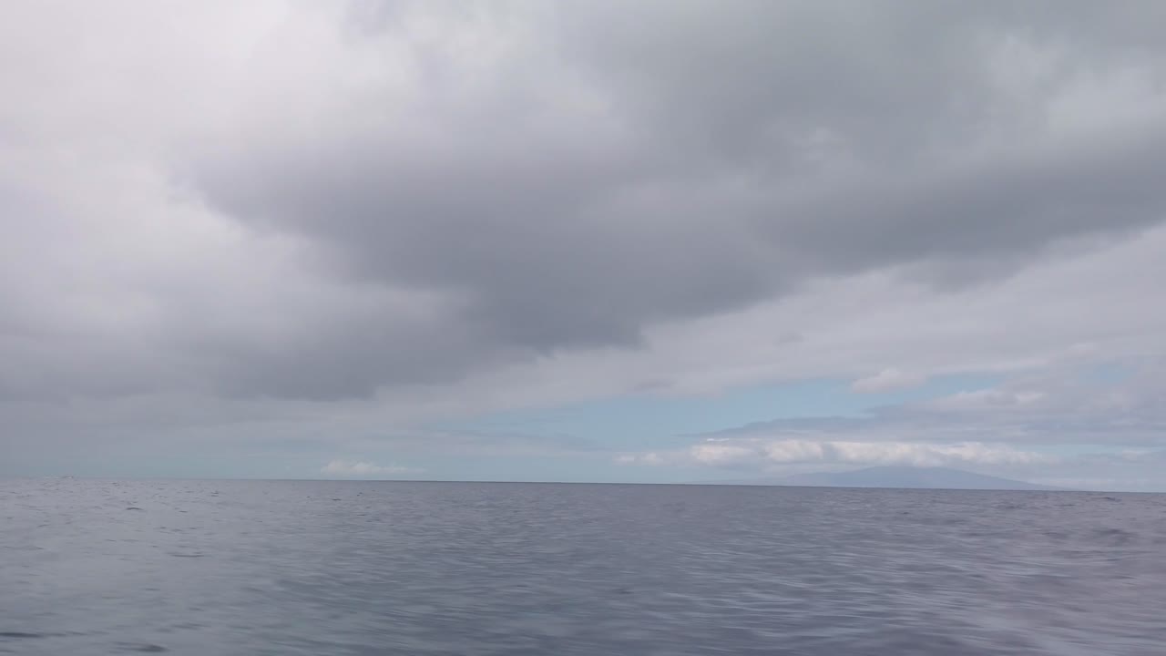 Gimbal panning POV shot from a moving boat of West Maui and the private island of Lanai from Molokini Crater off the coast of South Maui, Hawai'i