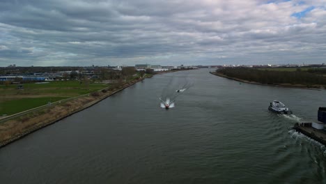 aerial view of boats and industrial ships navigating through the inland canal of zwijndrecht