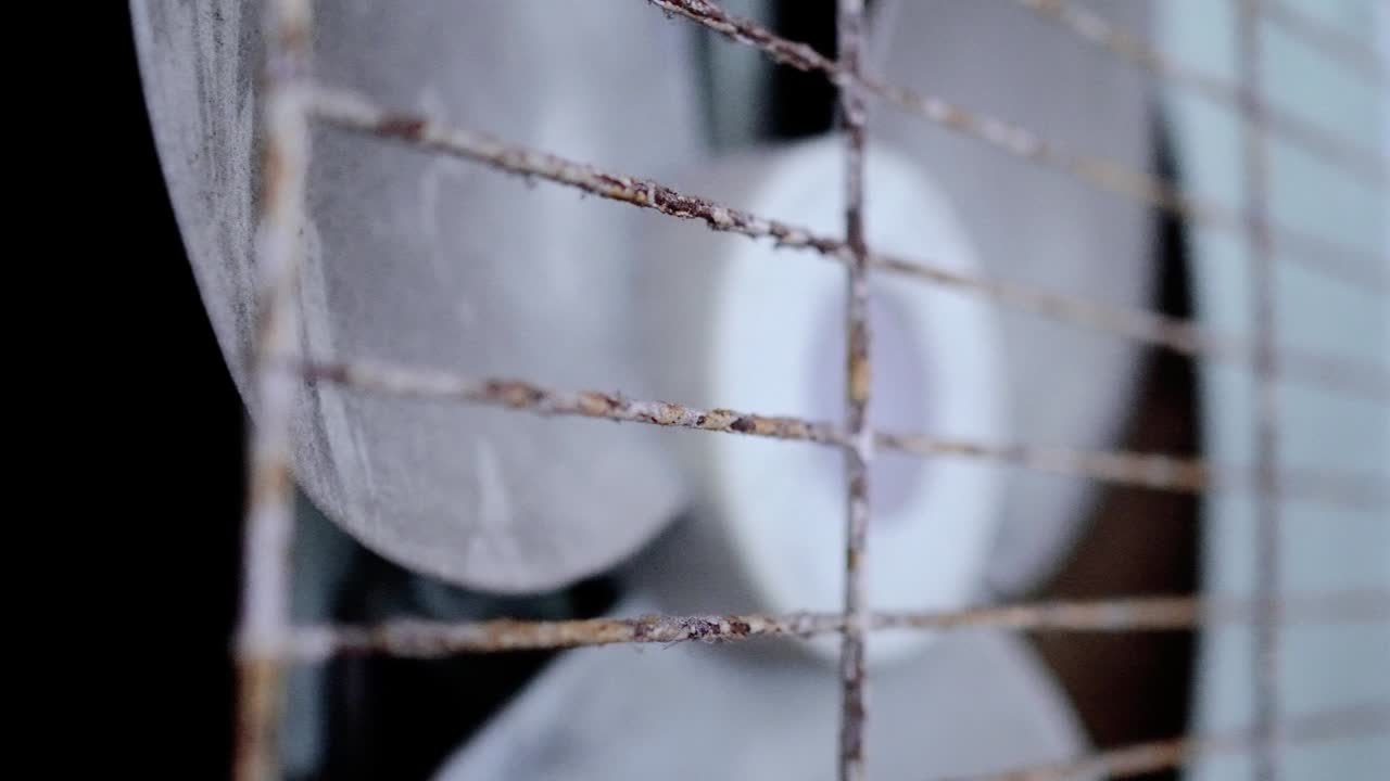 The old exhaust fan is on the wall of the apartment. Tilt shot from left to right.