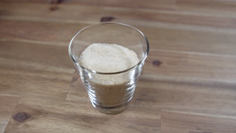 panning shot of brown sugar sitting in a jar