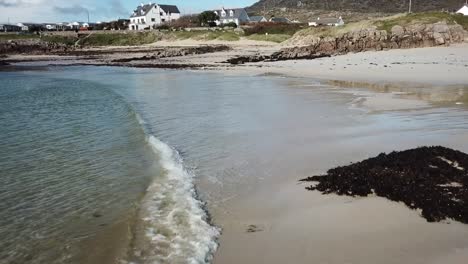 cllifden sandy beach in connemara, aerial view, waves crashing on the shore