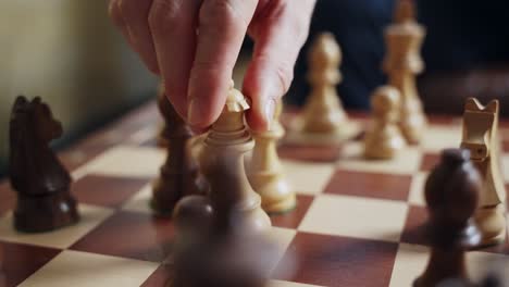 playing chess, a hand strategically moves the queen, symbolizing strategy, success, leadership, decision-making, competition, and power moves in business, life, and intellectual challenges. board game