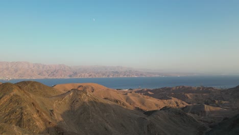 A-drone-view-of-travelers-relaxing-at-a-viewpoint-after-hiking-in-the-desert