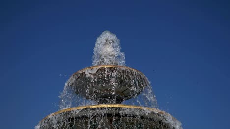 fountain classical form in three round bowls with cascade jets in city park.