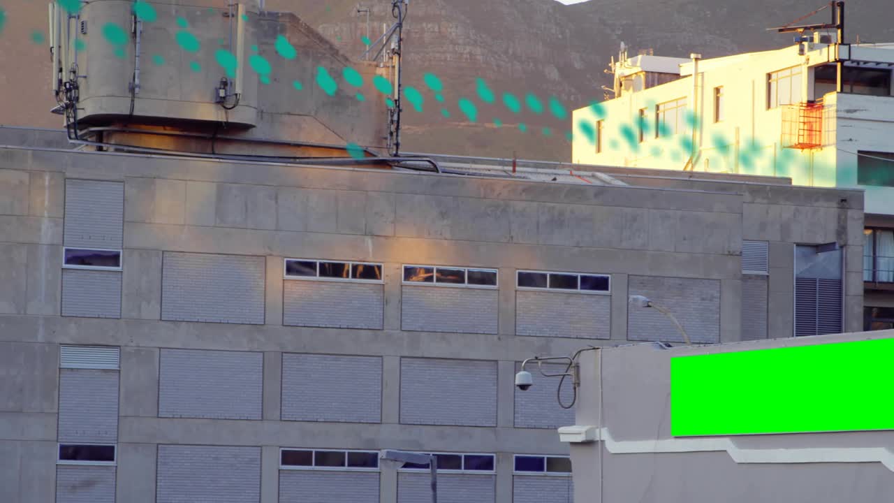 Teal particle band appearing upper-left, sweeping right across facade and highlighting billboard