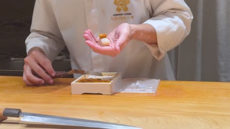 chef skillfully prepares sushi with precision and care