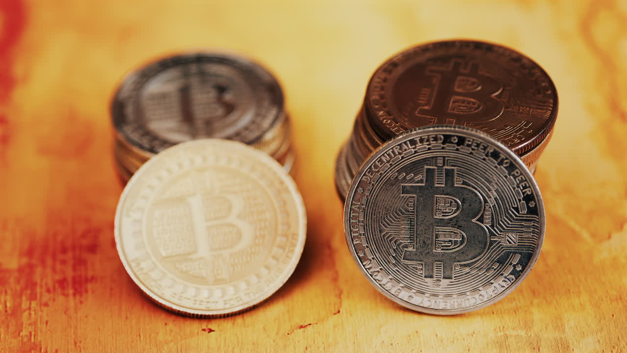 Close up of shiny physical Bitcoin coins stacked on a table