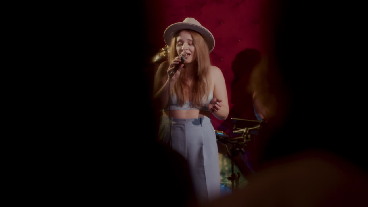 Female Singer on Stage with Band