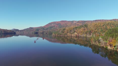 the verdant scenery mirrored on the lake's surface - drone flying forward