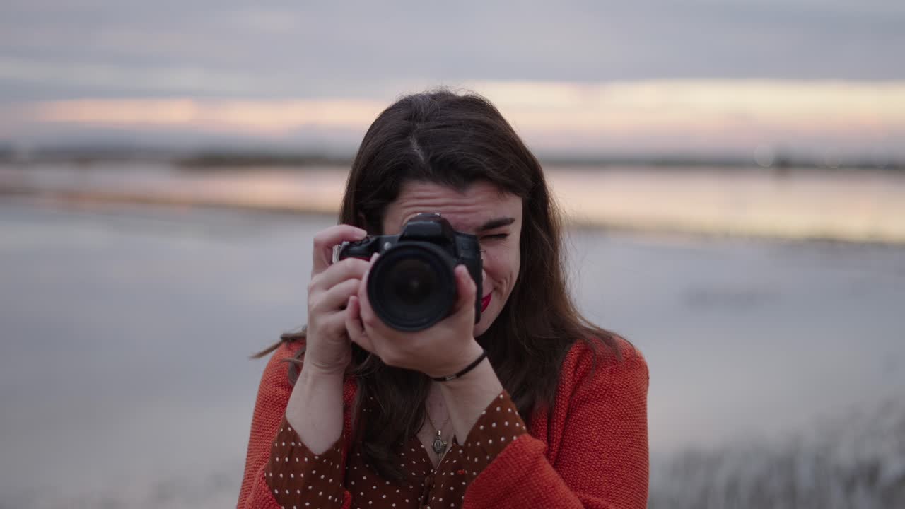 Woman Taking Pictures at Sunset