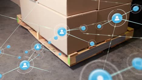 Network-of-profile-icons-against-multiple-delivery-boxes-on-a-palette-at-warehouse