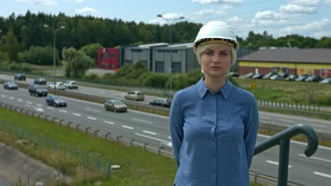 a professional woman engineer wearing a helmet to selt an example to worker of safety in the work place