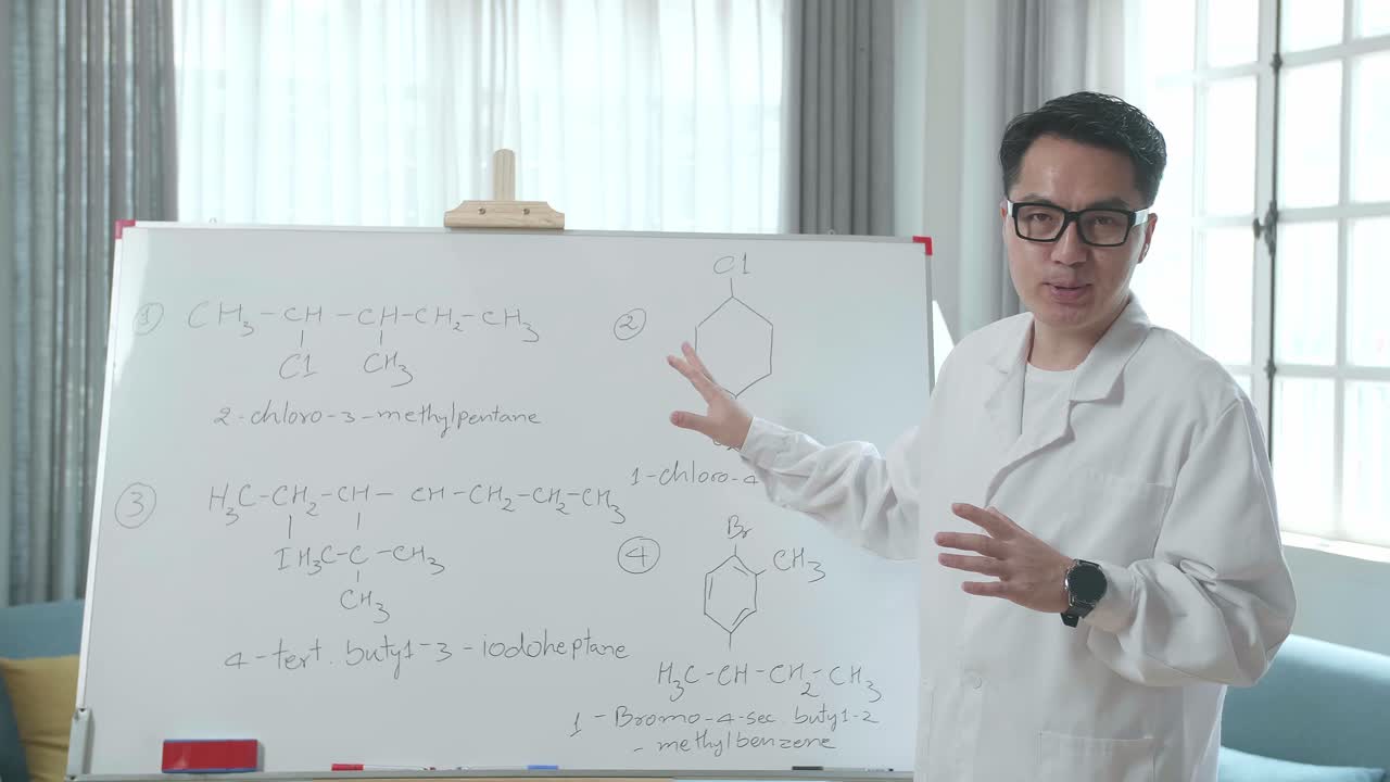 Asian Male Teacher With Glasses Teaching Chemist At Home