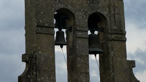 two old church bells in stone tower