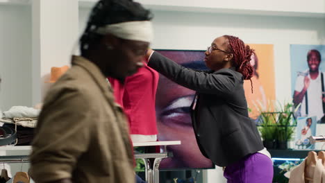 Worker-puts-clothes-on-sale-on-mannequin