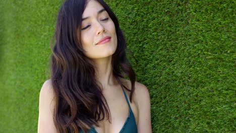 beautiful young woman wearing green bikini top