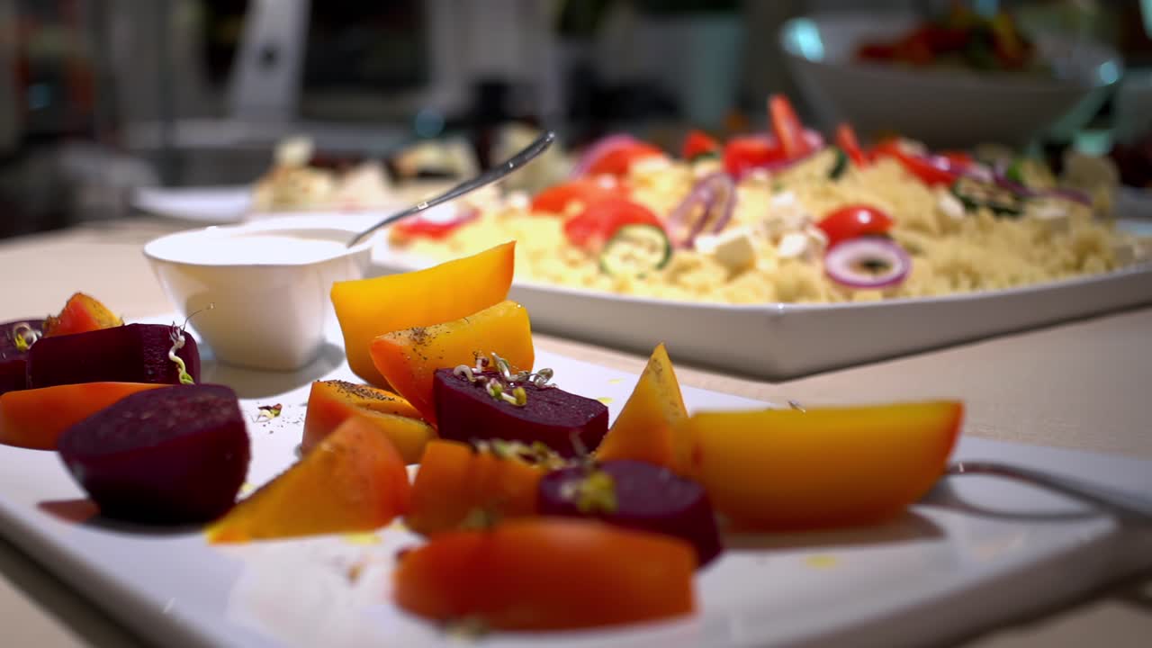 A table richly filled with cut vegetables and fruit