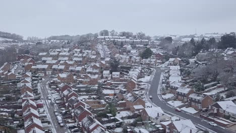 high sideways tracking drone shot of snowy exeter subburbs crop