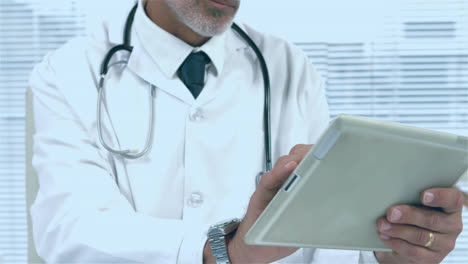 animation of red pattern over caucasian male doctor using tablet