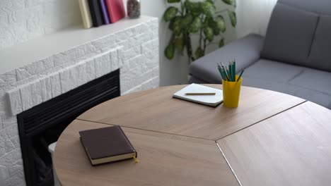 blank paper and pencils on the wooden table.