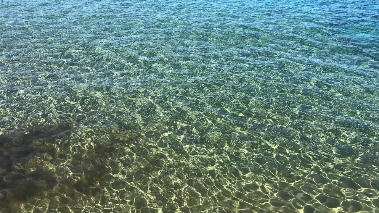 Transparent turquoise waters with sunlight reflections at Crete Island, Greece
