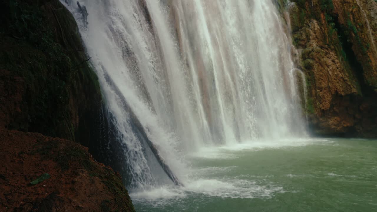 Close-up view of cascading water over rocks at El Limón Waterfall, capturing texture, speed, and raw natural power.