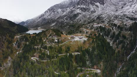 Drone-flight-over-winding-forest-road,-beautiful-and-peaceful-surroundings-for-a-cinematic-experience