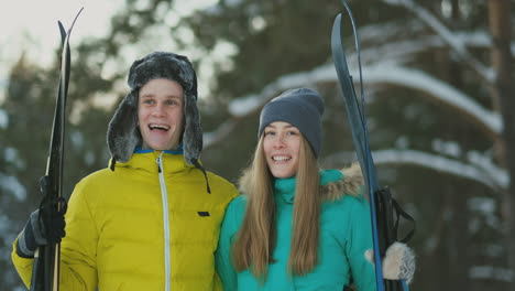 man and woman in love with ski equipment going to ski terrain