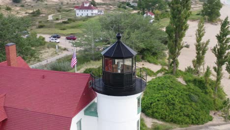 historic point betsie lighthouse in frankfort, michigan located along lake michigan with drone video circling