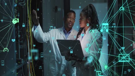 Animation-of-connections-with-icons-over-african-american-man-and-woman-working-in-server-room