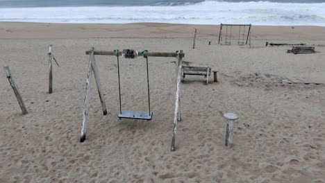 Wooden-structures-and-swings-at-Costa-Nova-Beach-on-a-cloudy-day-with-turbulent-sea-conditions