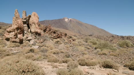 Pico-del-Teide-with-rocks-and-dry-shrubs-in-Los-Roques-de-Garcia,-Teide-National-Park-in-Tenerife,-Canary-Islands-in-spring