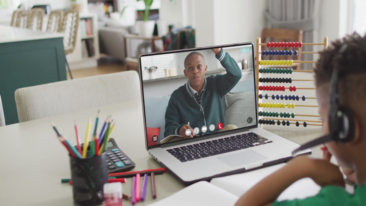 Composition of biracial boy on laptop online learning with african american schoolboy