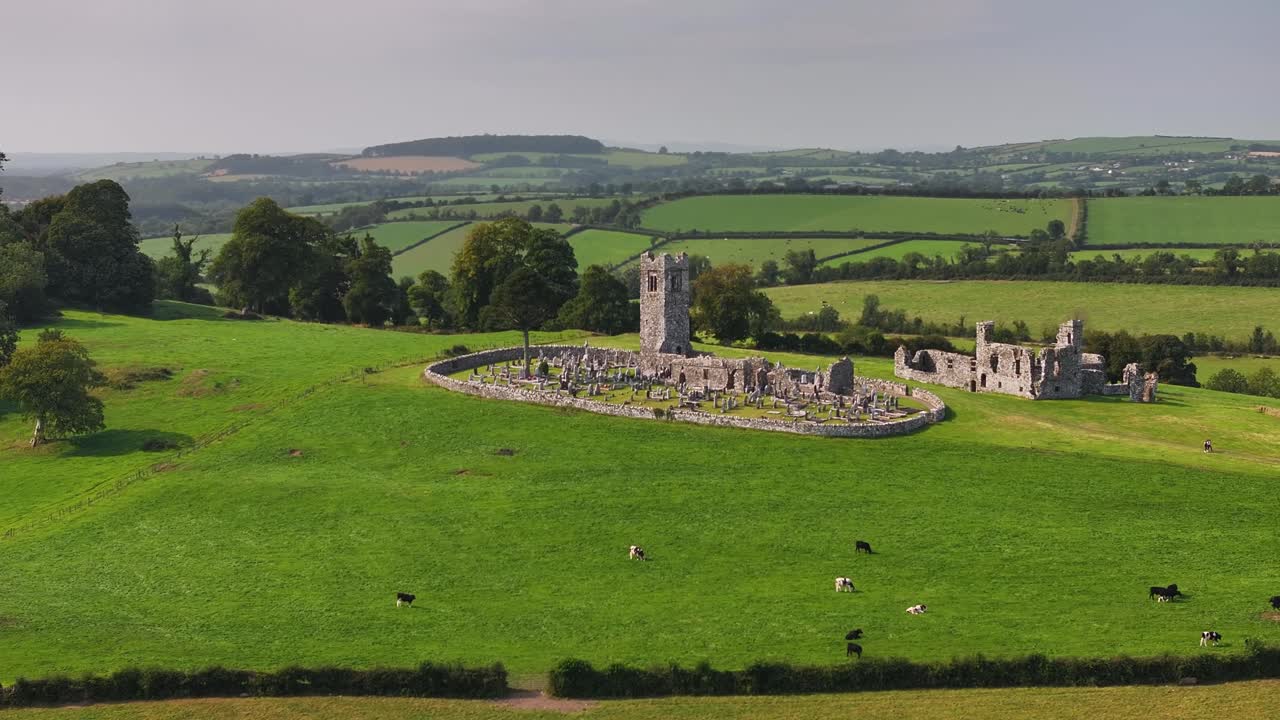 Hill of Slane with monastery building, tower and graveyard. Aerial panoramic. Ireland history