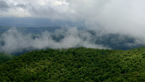 dramatic wilderness drone shot of the smokies under a rainy, fog-filled sky