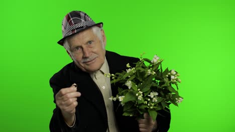 Elderly-caucasian-grandfather-man-with-bouquet-of-flowers-and-ring-goes-on-date