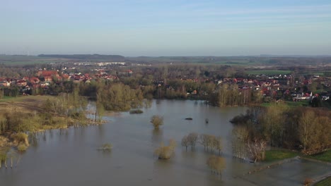 a drone flight over green  meadows and fields, which were flooded after heavy rain