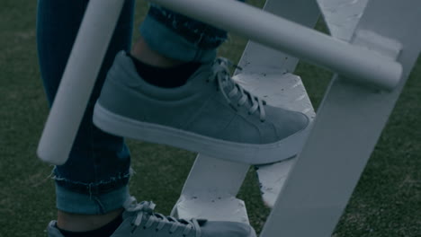 close up woman climbing ladder in playground wearing shoes girl walking up steps enjoying fun outdoors success concept