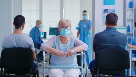 senior woman with walker in hospital waiting area