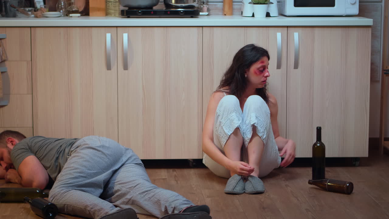 Wife drinking alcohol near drunk husband