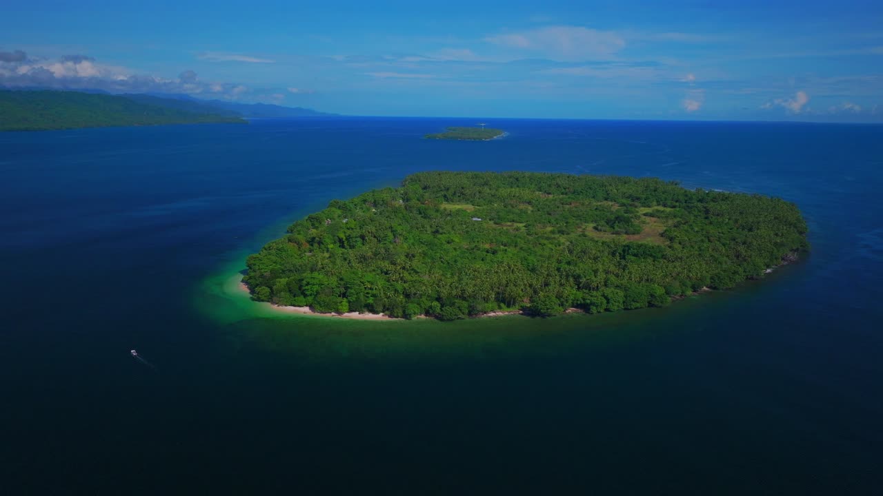 Yuo Island fishing boat remote pristine untouched tropical Mushi island coastline village Wewak Madang Cape Wom Papua New Guinea aerial drone PNG dry season summer morning blue sky circle left