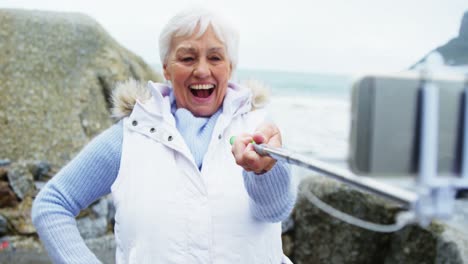 senior woman taking a selfie from selfie stick