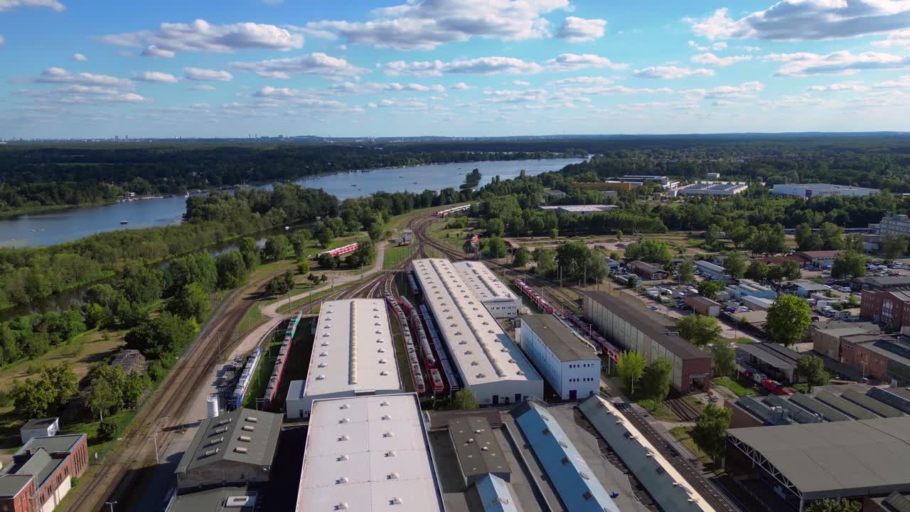 Hennigsdorf railway factory train depot overlooking the river in Brandenburg, Germany. Marvelous aerial view flight panorama orbit drone