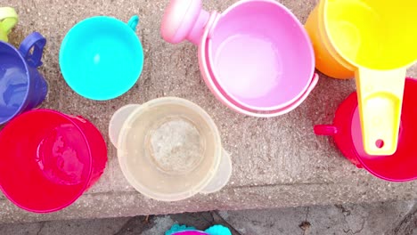 top down shot of kid's colorful toys on the ground, outdoor