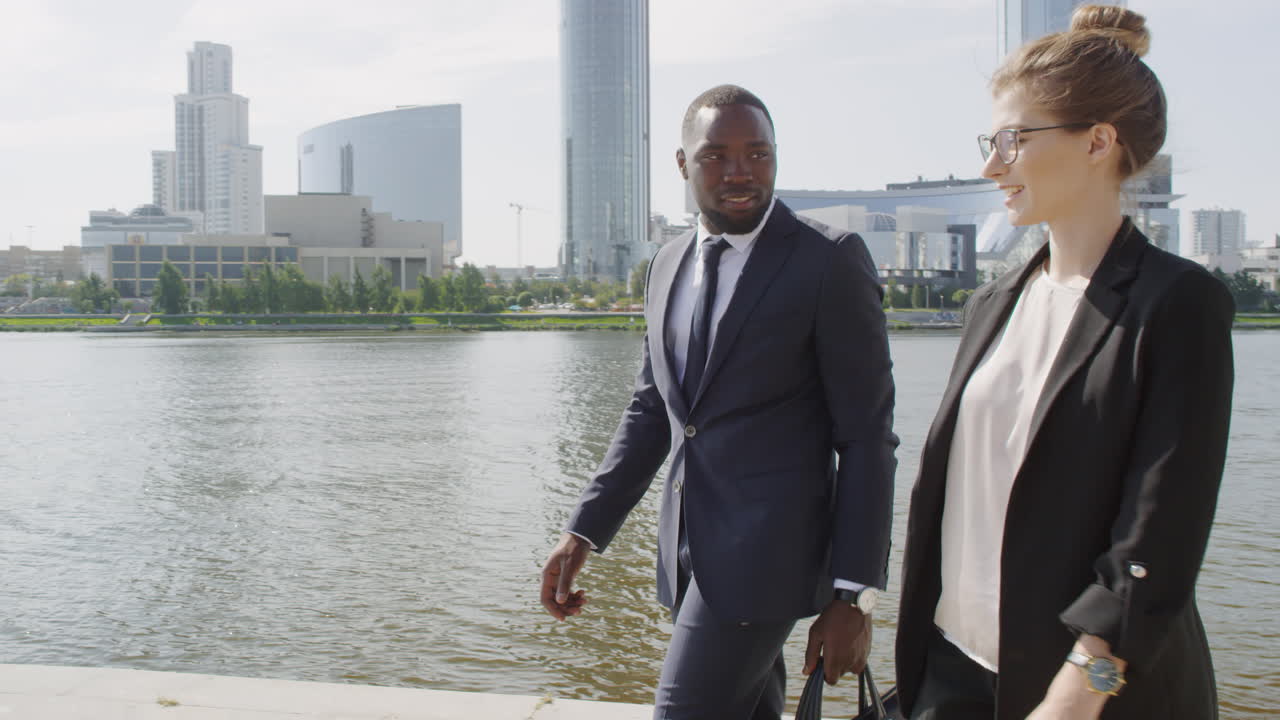 Multiethnic Business Partners Walking Along River